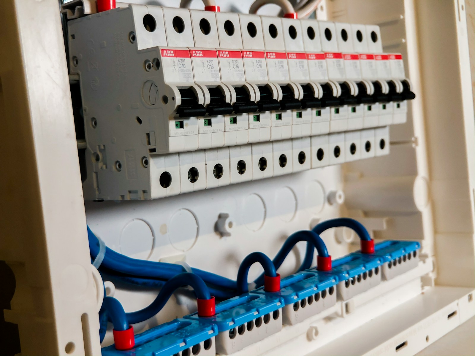 Row of white circuit breakers seated in a residential load center