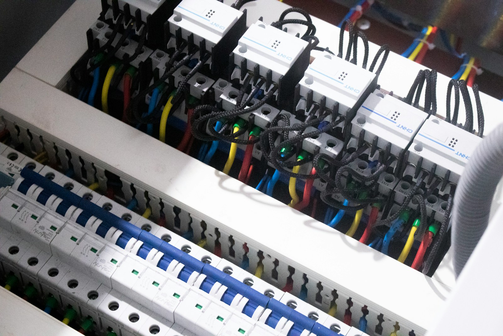 Interior of an electrical junction box with colour-coded conductors terminated neatly